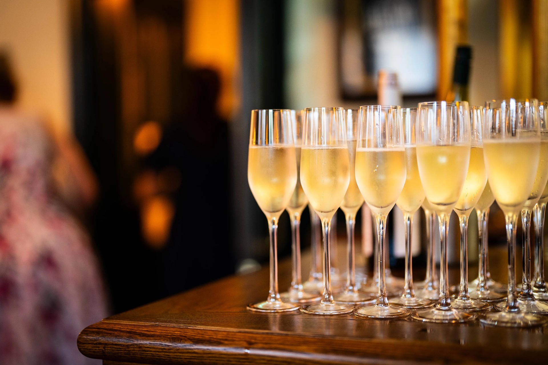 Champagne glasses on a bar at The Admiral Hardy, suggesting celebration and elegance, perfect for private hire events in Greenwich.