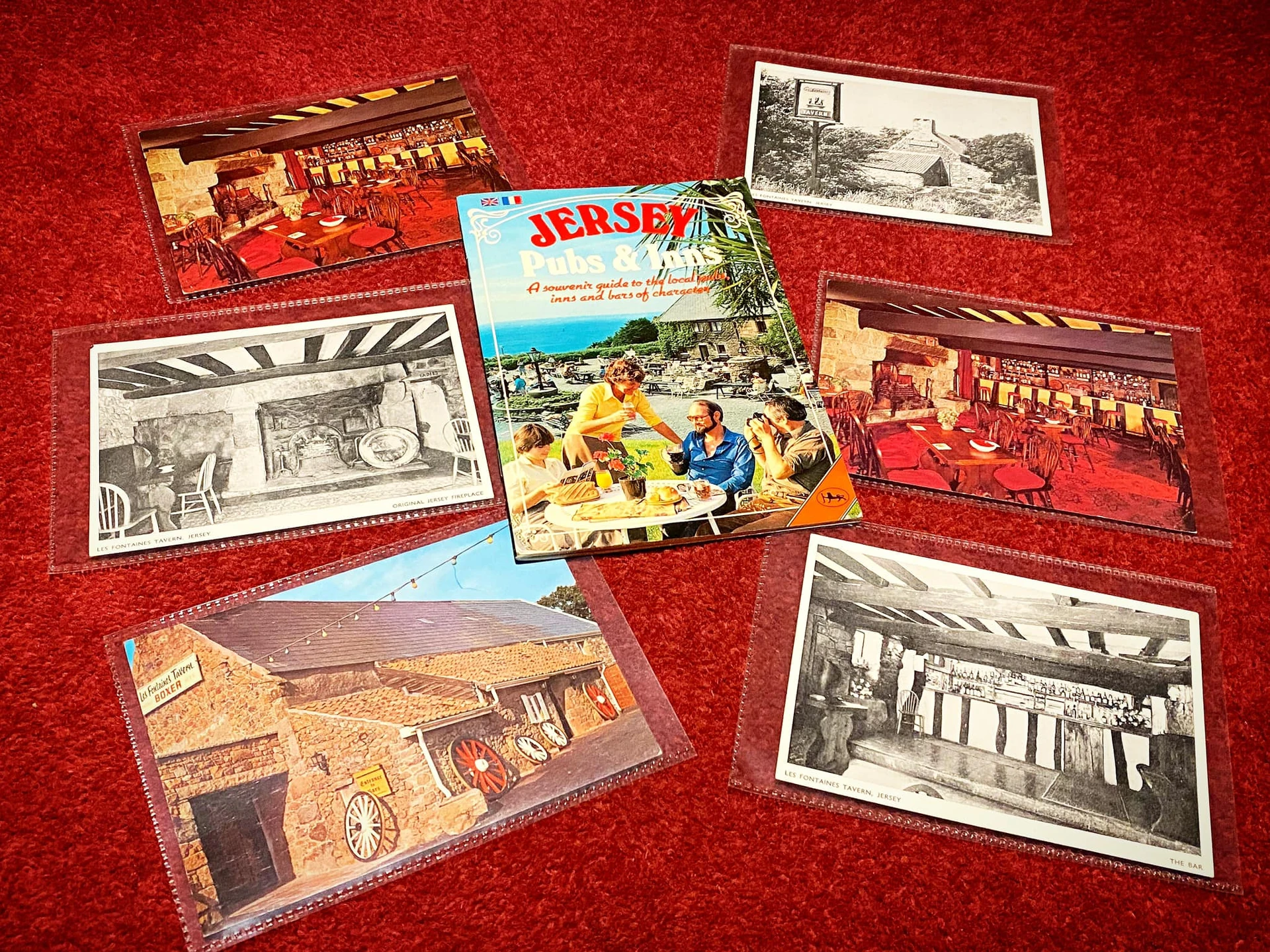 A vibrant red carpet serves as the backdrop for six distinct book covers, each showcasing a unique image of a bustling street scene. The covers, in various sizes and orientations, are arranged in a circular pattern, creating a visually appealing display. The central image features a lively street scene, while the outermost cover showcases a serene garden. The book covers are a mix of black and white, with some featuring vibrant colors, and the text on the covers is in English. The arrangement of the book covers and their vibrant colors create a visually appealing and engaging display.